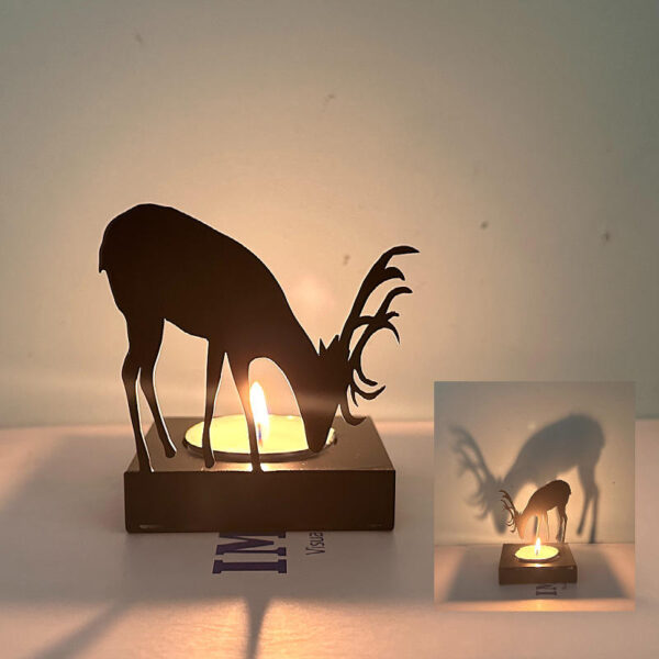Silhouette deer candle holder casting warm shadow light decor