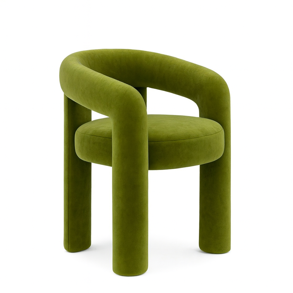 Green modern upholstered accent chair with curved backrest and cylindrical legs in a minimalist interior.