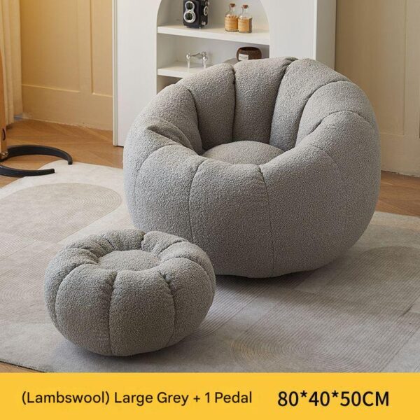 Large grey sherpa bean bag chair with matching ottoman in a modern living room