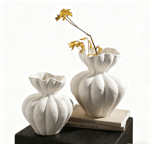 Minimalist white sculptural vases set on books, modern decorative ceramic vases for home decor photography.