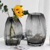 Two Transparent Geometric-Textured Decorative Vases (One Holding a Yellow Flower)
