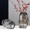 Tabletop Decor Scene: Transparent Vase With Red-Branched Plant & Transparent Polyhedral Decorative Piece