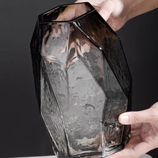Hand Holding Transparent Geometric-Textured Decorative Vase