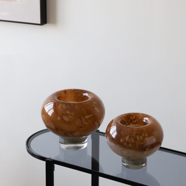 Two Brown Textured Decorative Ornaments (Smooth Curved Shapes, Displayed on Table)