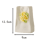 A cute healing-style white ceramic vase with 3D hand-sculpted yellow rose decorations and a subtle wrinkled texture. Dimensions: 12.5cm height × 9cm width. Displayed against a clean white background, it’s ideal for small fresh flower arrangements or desktop decor.