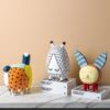 A set of three ins-style hand-drawn cartoon pet resin decorative ornaments, featuring an orange polka-dot patchwork cat, a closed-eye teardrop pet with dashed lines, and a big-eared mischievous creature. Displayed on a marble countertop against a peach backdrop, they add playful, vibrant charm to modern living spaces, kids' rooms, or desks