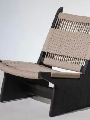 A wabi-sabi style lounge chair featuring a sleek black solid wood frame and handwoven natural rope upholstery on the backrest and seat. Displayed against a clean white background, it highlights the contrast between the sturdy frame and breathable woven texture, ideal for modern, serene home spaces.