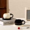 Ceramic Coffee Cups – Black and White Set Black and white ceramic coffee cups displayed on a minimalist table setting