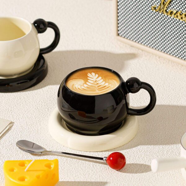 Black Ceramic Coffee Cup – Minimalist Style Black ceramic coffee cup with latte art, minimalist tableware for modern cafe and home use