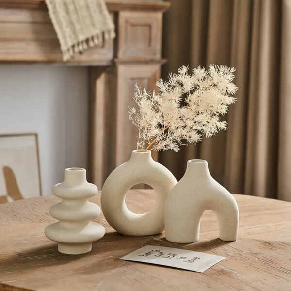 boho-ceramic-vase-set-of-3-lifestyle Bohemian matte bisque ceramic vase set of 3 with arch, donut and ribbed shapes styled on a wooden table