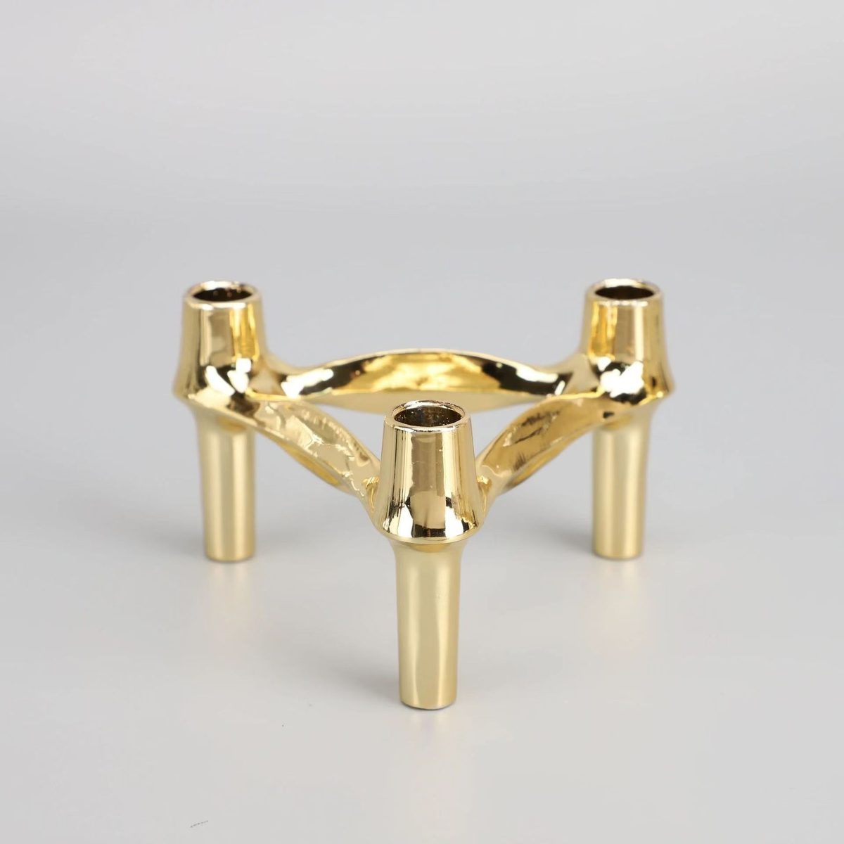 Polished gold detail — ball sockets and sculptural arms