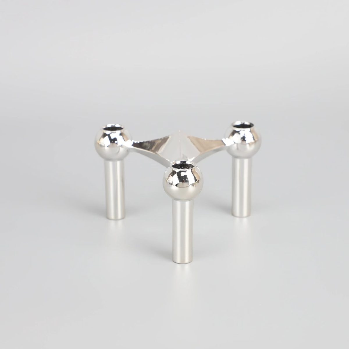 Polished chrome detail — sculptural arm profile