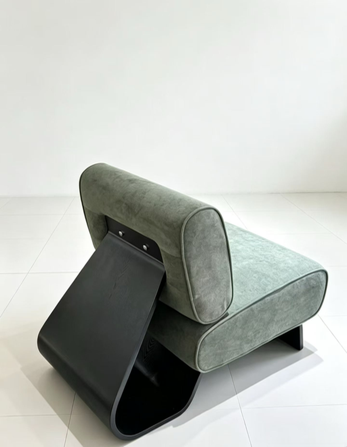 Sage green velvet slipper accent chair showing curved black bentwood frame from the rear