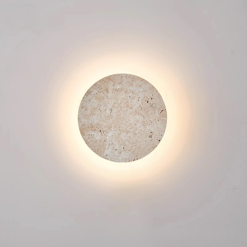 Japanese wabi-sabi travertine round wall lamp with warm backlight halo, close-up glow
