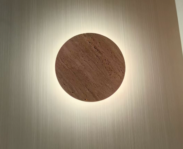 Real customer unboxing photo of the travertine wall lamp disc with packaging