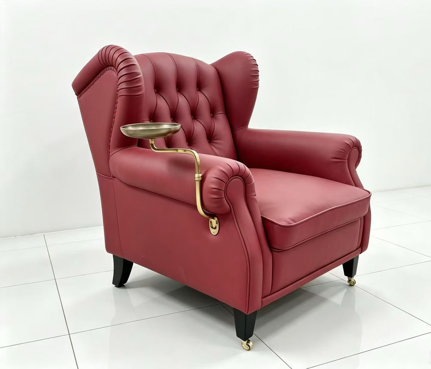 Burgundy tufted armchair with brass swing-arm rotating tray table mounted on the armrest, side view
